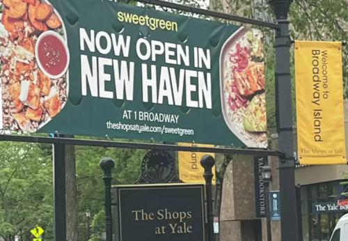 Sign reads: Sweetgreen now open in New Haven at Broadway Shops at Yale