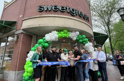 Group of people at the ribbon cutting in front of Sweetgreen location