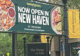 Sign reads: Sweetgreen now open in New Haven at Broadway Shops at Yale