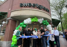 Group of people at the ribbon cutting in front of Sweetgreen location